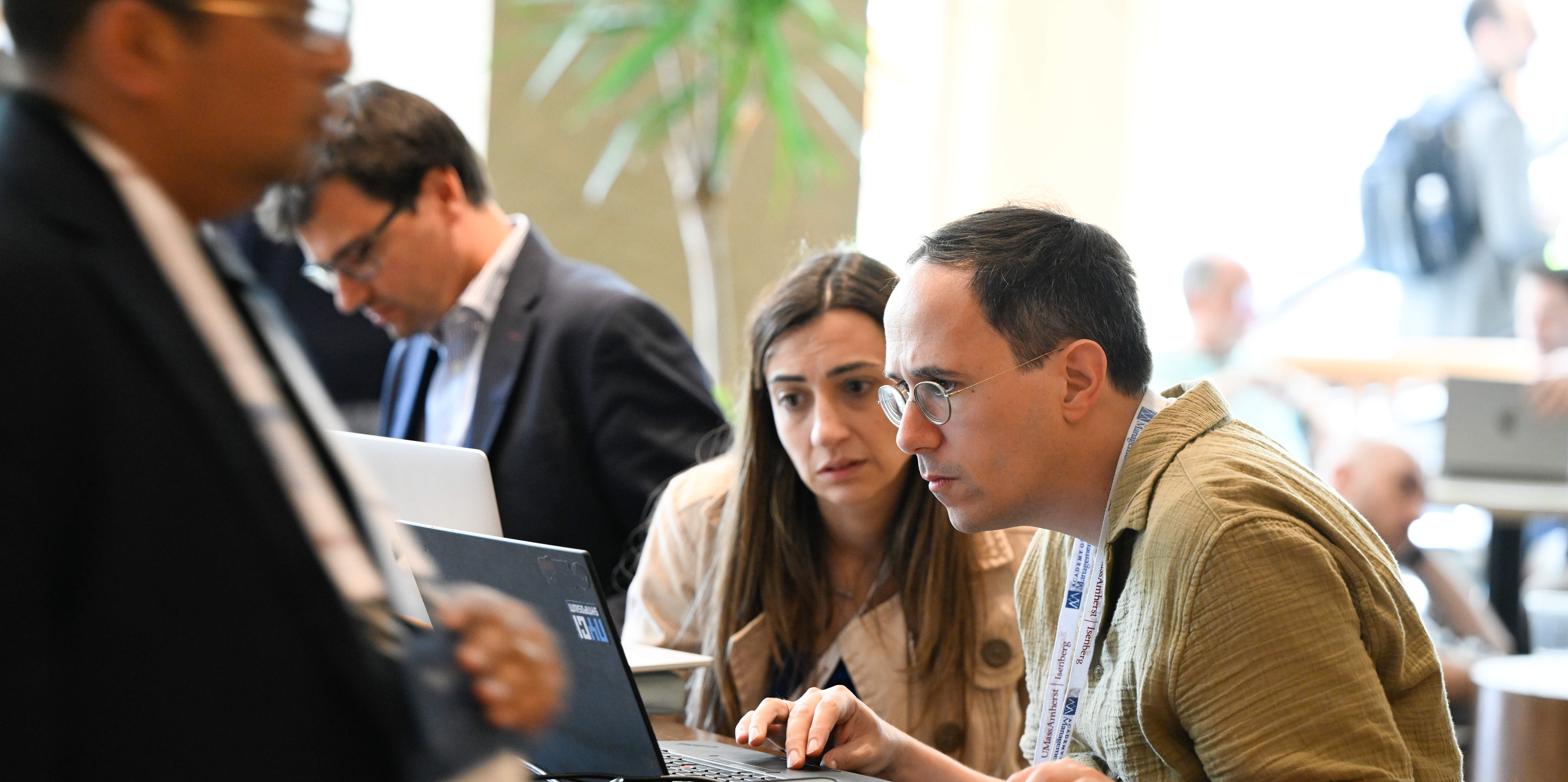 Image of two men working over computer